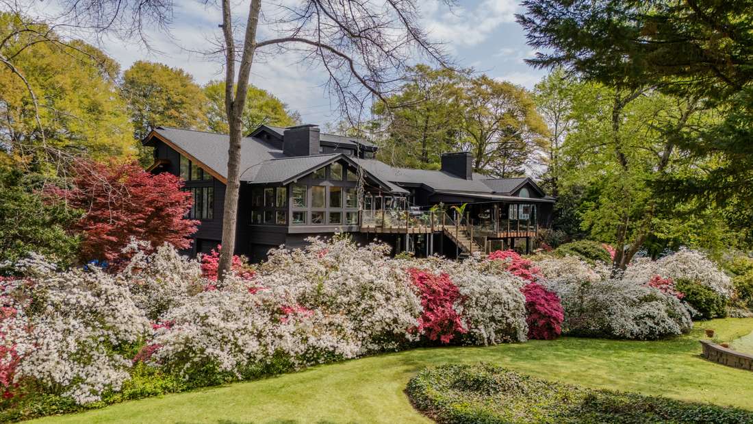 The house across the lawn behind massed bloom